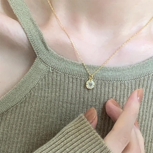 Elegant 925 sterling silver gold necklace with round zircon pendant worn on model