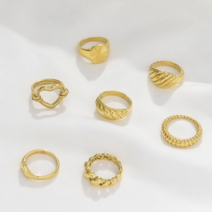 Collection of seven minimalist gold stainless steel hollow heart and twist rings for women