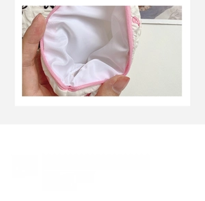 Inside view of a white textured cosmetic bag with pink bow pattern and large capacity