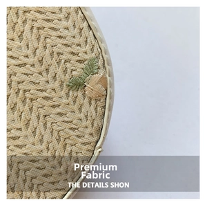 Detail of straw woven bag with fine mesh layer and green leaf embroidery finish
