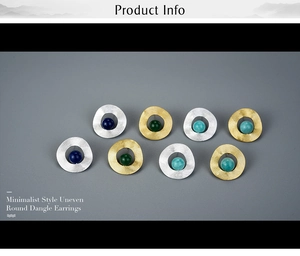 Detail of minimalist uneven round dangle earrings in gold and silver finish with colorful beads