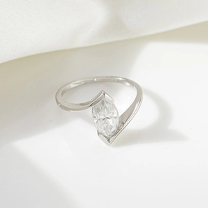 Macro shot of marquise moissanite ring with minimalist silver band and white gemstone