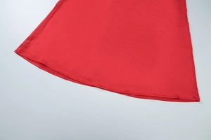 Close-up of the smooth red satin fabric hem on this sexy mesh long sleeve dress