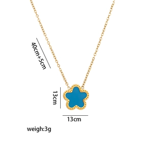Detail view of a gold clover necklace with blue petal pendant including size and weight specs