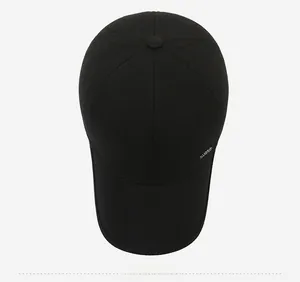 Top view of black twill baseball cap with metallic logo detail and high density fabric