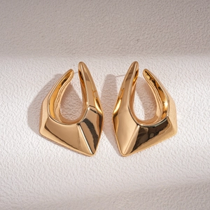 Polished 18K gold plated geometric U-shaped earrings on a beige textured background