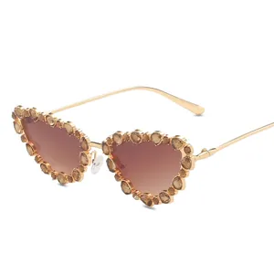 Luxe heart-shaped sunglasses with gold metal frame and amber crystal embellishments