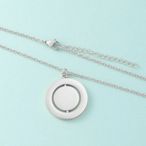 Detail of silver stainless steel rotating geometric pendant with adjustable chain