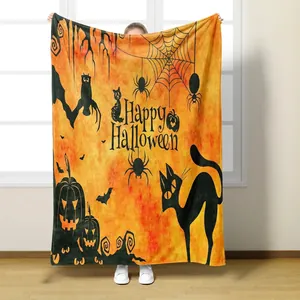 Soft Halloween flannel blanket with pumpkin, black cat and bat prints in orange and black
