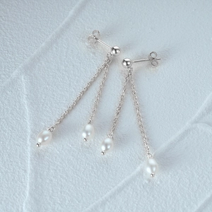 Detailed view of S925 silver long tassel earrings with lustrous drop pearl accents