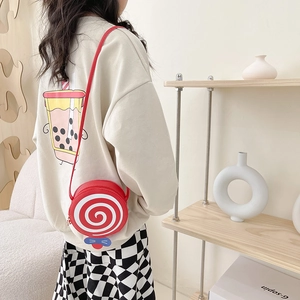 Red lollipop pattern children's crossbody bag with blue bow and adjustable shoulder strap