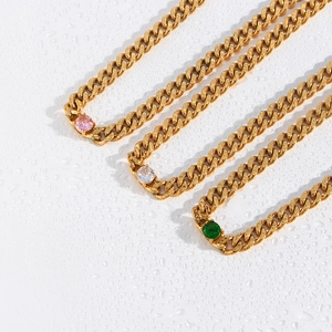 Detail of 18K gold Cuban chains featuring pink, white, and green round-cut zircons