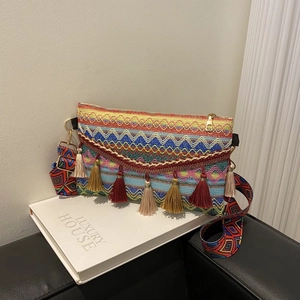 Detailed close-up of bohemian woven crossbody bag with colorful patterns and tassels