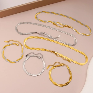 Detailed close-up of 18K double-layered gold and silver snake bone chain jewelry