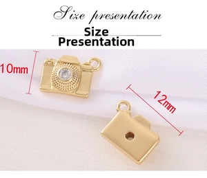 Detail view of gold camera pendant with cubic zirconia inlay showing 12x10mm dimensions