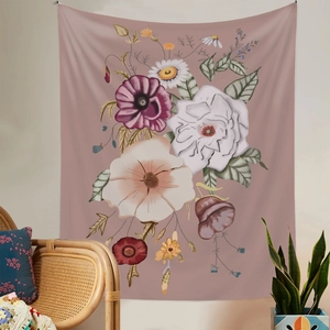Detail view of a floral wall tapestry hanging above a rattan chair in a cozy room