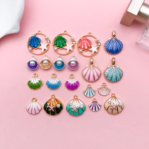 Detailed view of colorful enamel shell and starfish pendants with pearls for DIY jewelry