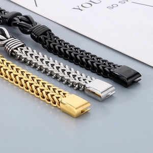 Detail of twisted wheat chain bracelets in gold, silver, and black polished steel
