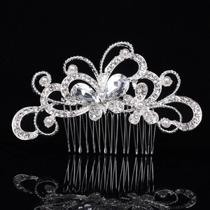 Elegant bridal hair comb with silver butterfly design, rhinestones and pearls on black surface