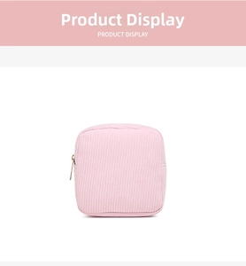 Macro shot of light pink corduroy texture and golden metal zipper on the square pouch