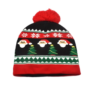 Close-up of festive knit hat featuring Santa Claus, Christmas tree and snowflake patterns