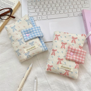 Charming bow fabric book covers in pink and blue floral patterns with plaid straps