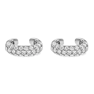 Macro detail of C-shaped ear cuffs with pavé-set zircons on a clean white background