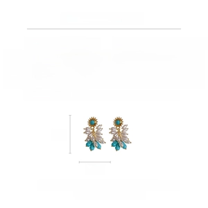 Detail view of vintage luxury teardrop tassel earrings with turquoise and pearls
