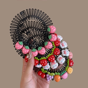 Close-up of children's hair combs featuring colorful resin fruit and animal charms