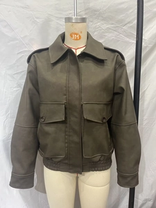 Close-up of olive green PU leather jacket with cargo pockets and elasticated waist