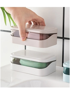 Detail of hand lifting grey double-layer soap box with transparent window and drain lid