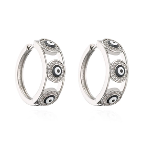 Macro shot of silver hoops with sparkling cubic zirconia inlaid evil eye designs