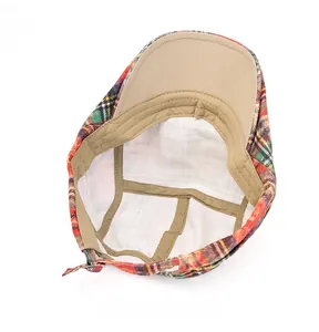 Detailed interior of plaid beret showing beige cotton lining and metal adjustment buckle
