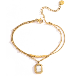 Detail of double-layer gold stainless steel anklet with shell pendant and S.Steel tag