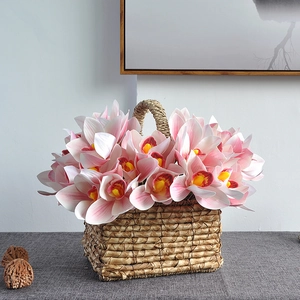 Pink gradient artificial orchid in woven grass basket for elegant home table decoration