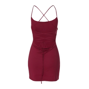 Detail of red backless dress featuring cross-strap ties and smooth fabric texture