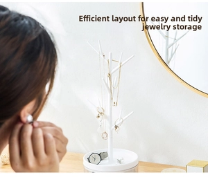 Detail view of white tree branch jewelry organizer with tray for rings and necklaces