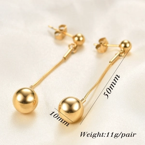 Macro detail of 10mm gold sphere earrings with 50mm chain length and polished finish