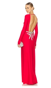 Detail of red backless dress with long sleeves and silver leaf-shaped crystal decor