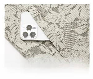 Detail of a slanted side pocket on a printed jacket showing depth with a phone inside