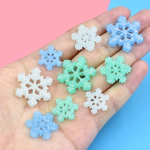 Mix of luminous snowflake glitter resin charms in white, blue and mint for DIY crafts
