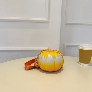 Detailed view of yellow and white striped round shoulder bag on a minimalist table