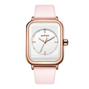 Detail of square quartz watch with rose gold case, pink strap, and blue crown jewel