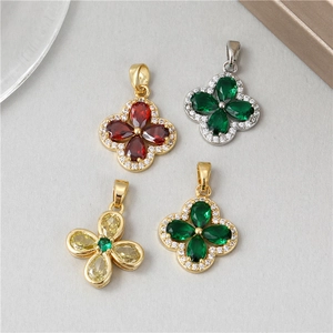 Four-leaf clover pendants in red, green, and yellow stones with sparkling crystal borders