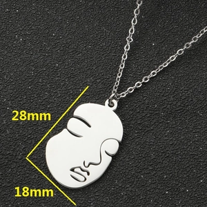 Abstract face pendant necklace in minimalist silver steel, 28mm x 18mm artistic style