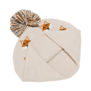 Close-up of knit baby hat featuring orange cartoon fox patterns and fluffy pompom