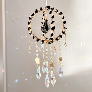 Golden crystal suncatcher with black crushed stones and hanging sun prisms for home decor