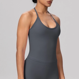 Detail view of the seamless charcoal grey sports bra with cross-back tie design
