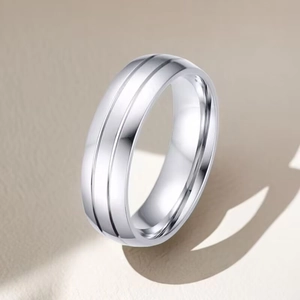Macro shot of silver titanium steel ring featuring sleek parallel grooves and polished finish