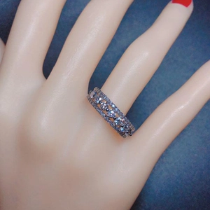 Close-up of triple layered silver ring with zircon stones worn on a finger